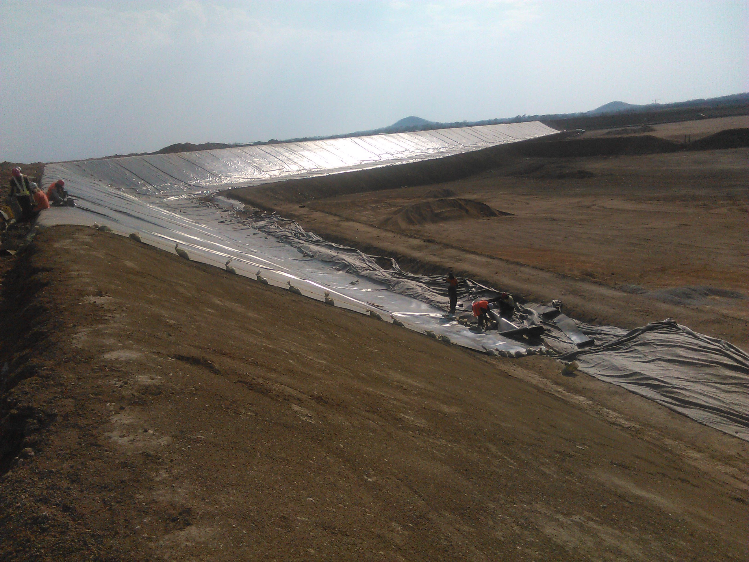 Large HDPE liner installation on mining pond