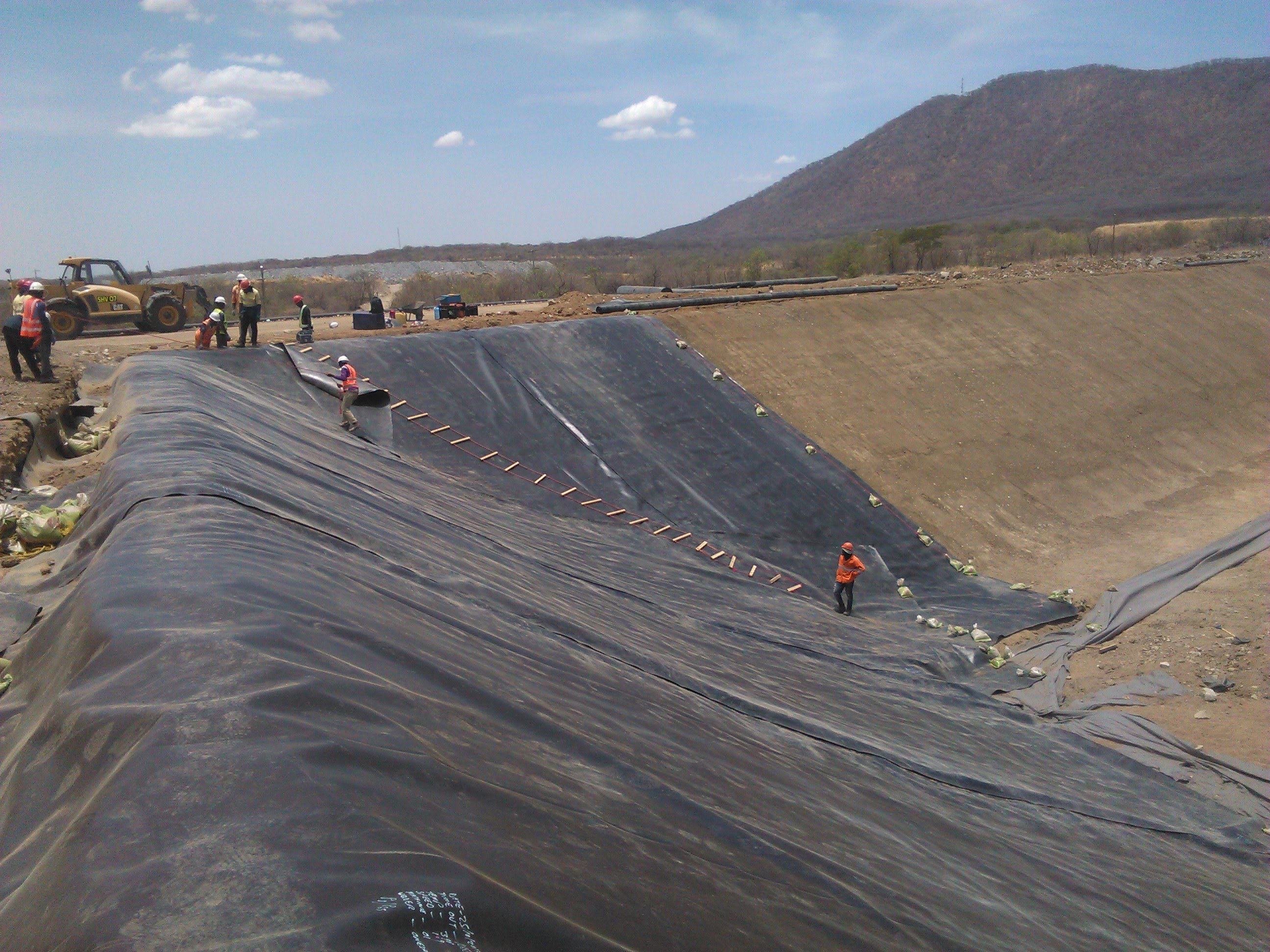 Large HDPE liner installation on mining pond
